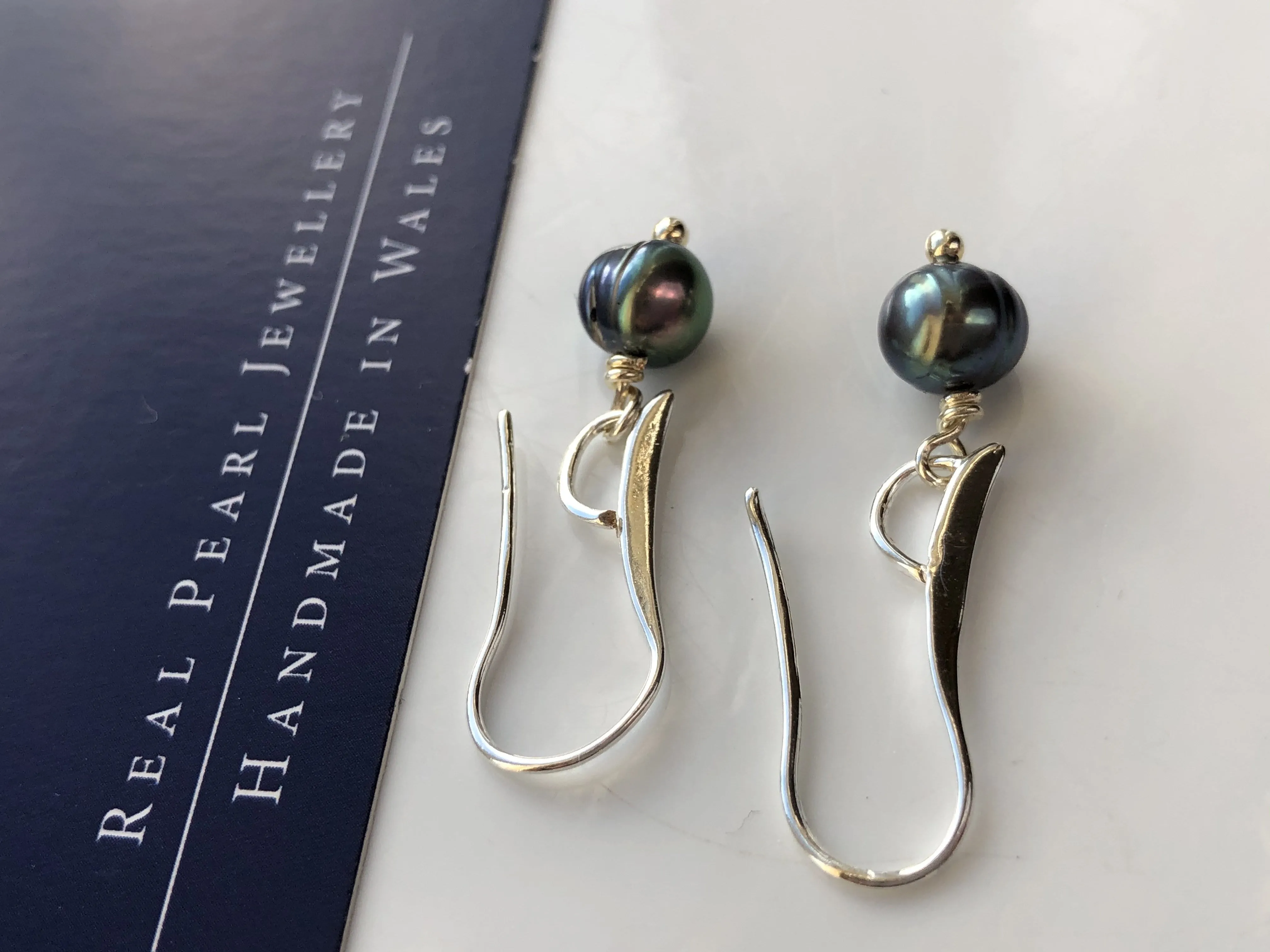 Earrings: Single green peacock pearl drop earrings on longer hook - classic