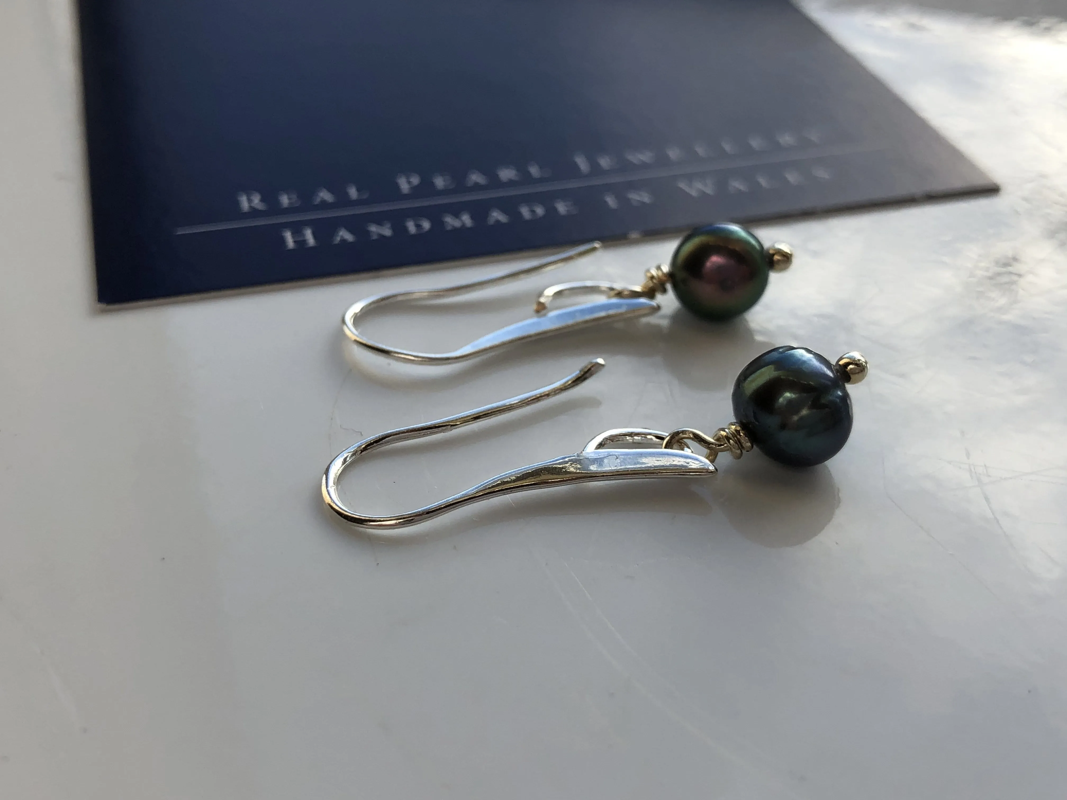 Earrings: Single green peacock pearl drop earrings on longer hook - classic