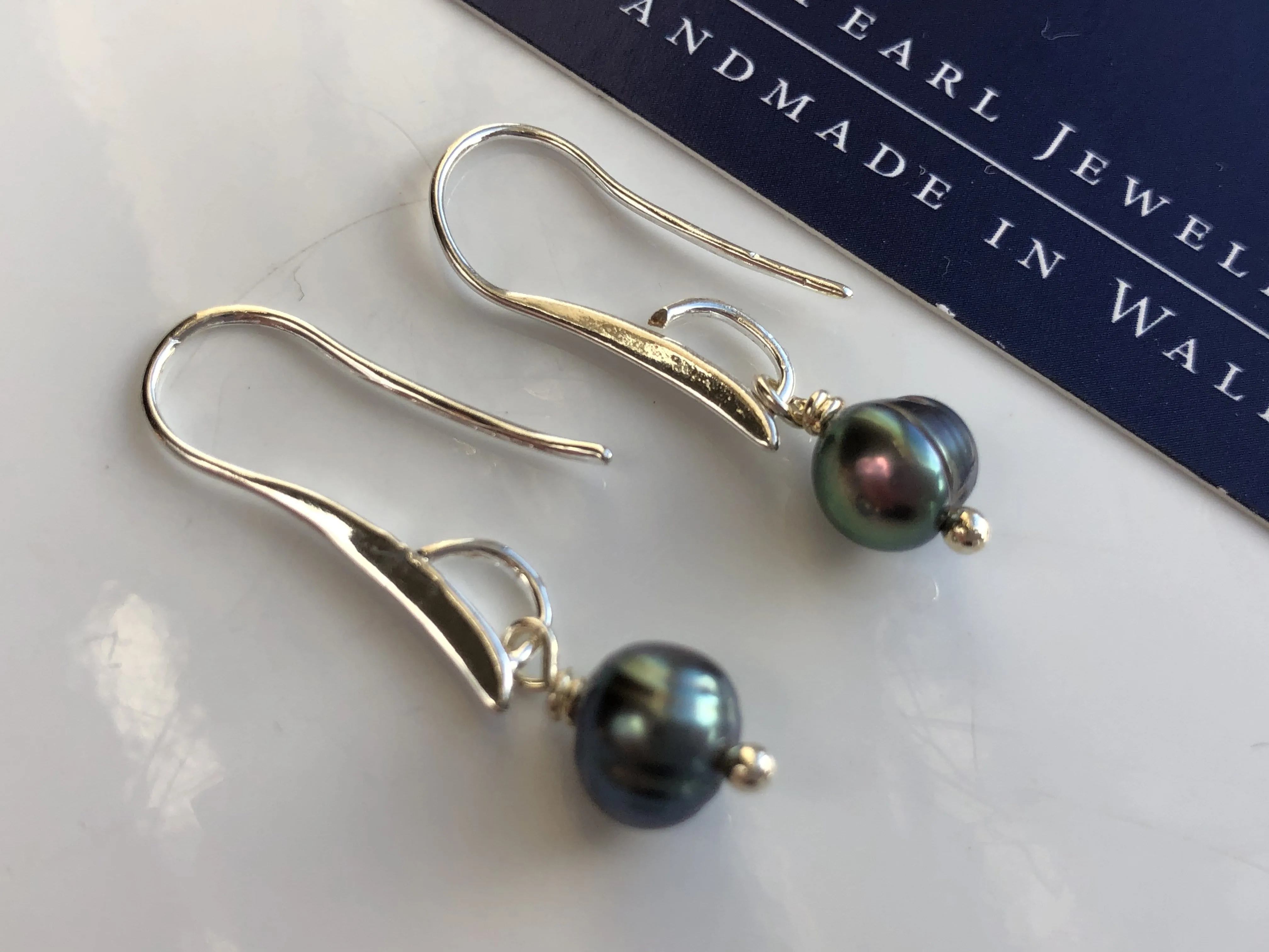 Earrings: Single green peacock pearl drop earrings on longer hook - classic